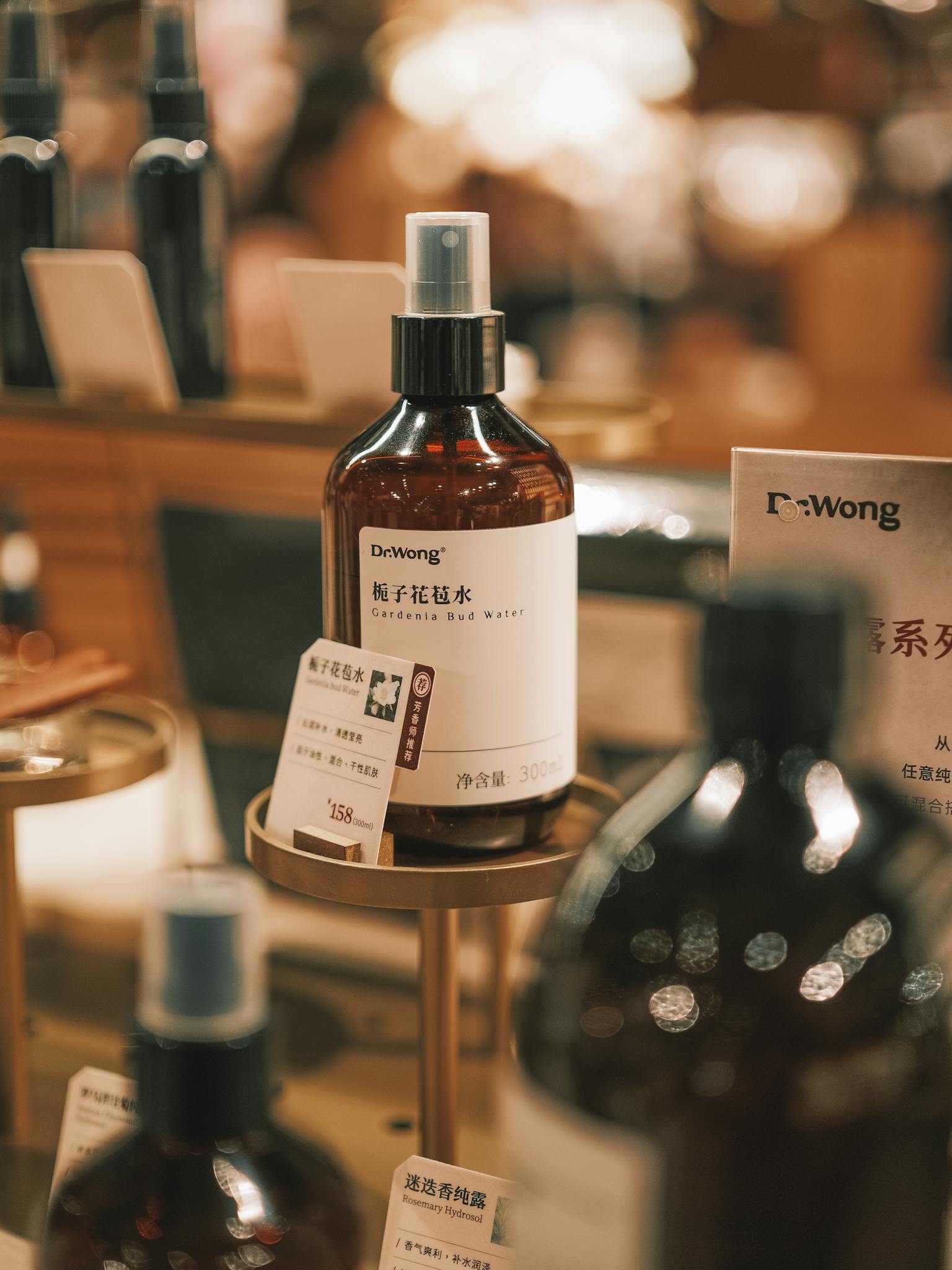 Close-up view of skincare product bottles in a warm, elegant retail setting.